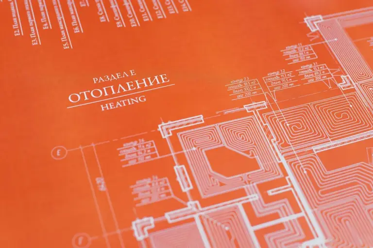 Orange blueprint-style diagram of a heating system with circuit-like pathways and labeled sections.