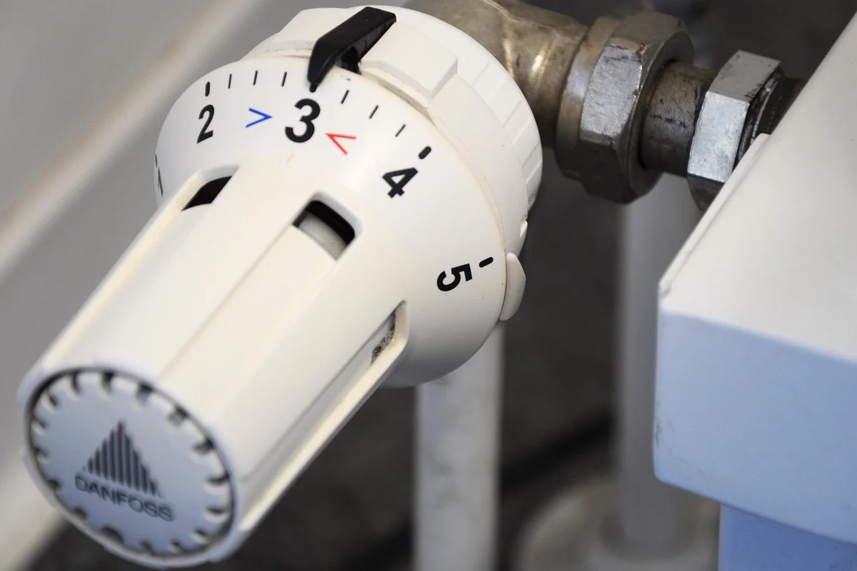 Close-up of a radiator thermostat knob, representing alternative heating options for hermit crab enclosures.